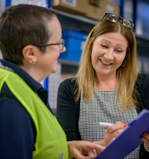 A female warehouse working discussing with a collage