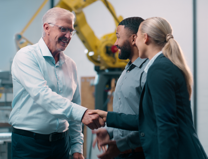 Robotics, handshake and engineering team in factory for manufacturing agreement